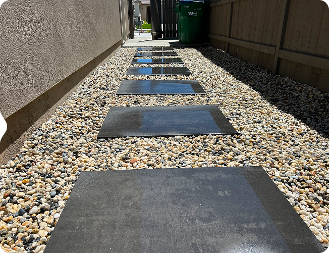 Completed backyard with green lawn, planting beds, and patio